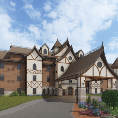 The image shows a large, castle-like building with multiple turrets against a blue sky, surrounded by landscaped gardens.